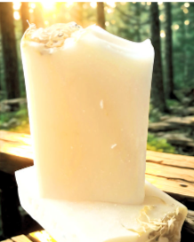 Offwhite Calendula & kawkawa soap on a wooden surface outdoors