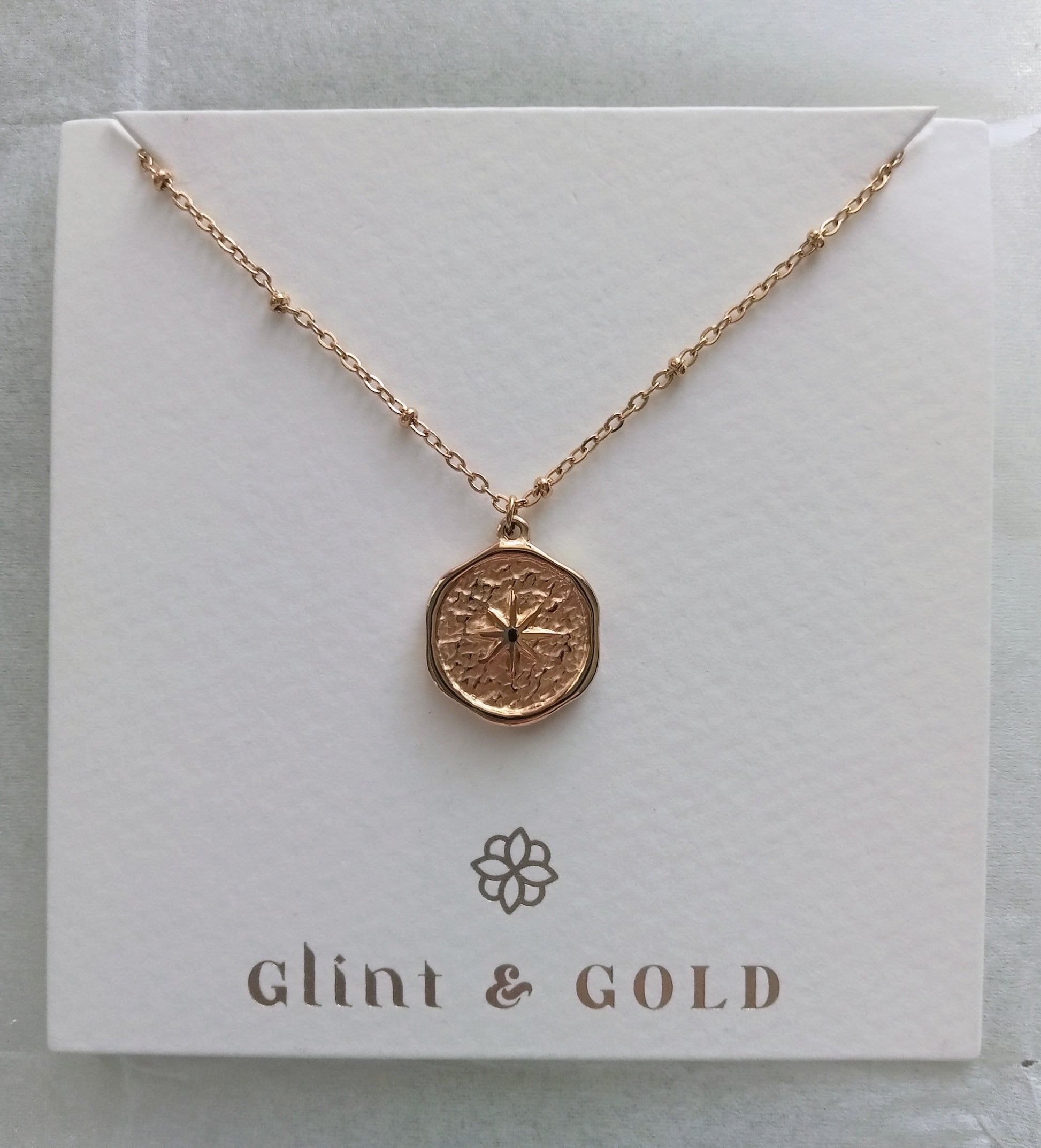 Rose gold necklace on a 'Glint & Gold' branded card