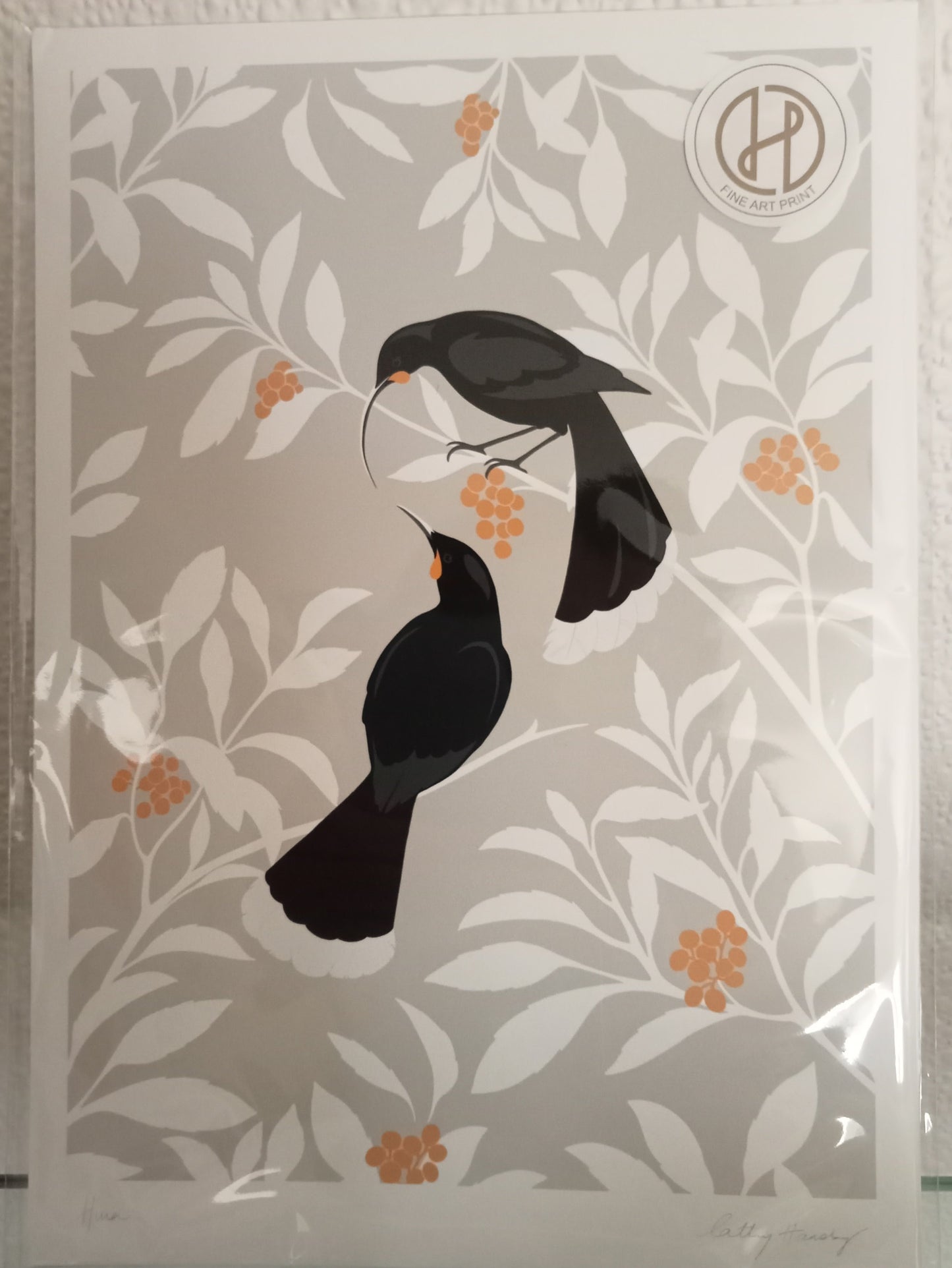 Decorative card with black Huia birds on a floral Koromiko pattern