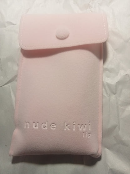 Pink suede-look pouch filled with the 2-pce lip-care items on white background.