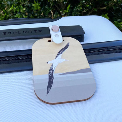 Luggage tag with albatross design on a suitcase