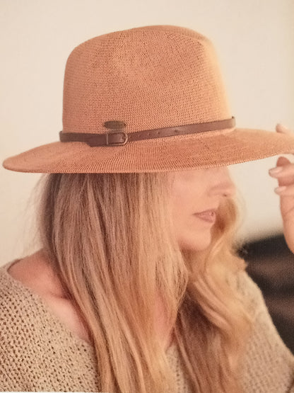 Female wearing a brown straw hat with a narrow brown band